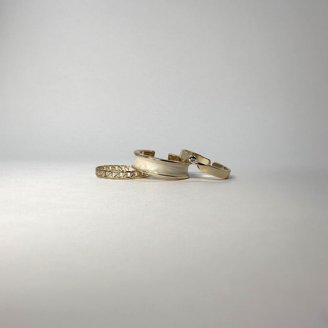 Chic and versatile Caelia Ring Set: 14k gold-plated trio with unique shapes and adjustable sizing for a perfect fit on any finger. Ideal for layering or standalone wear, radiating delicate and modern beauty, adding sophistication to daily style.