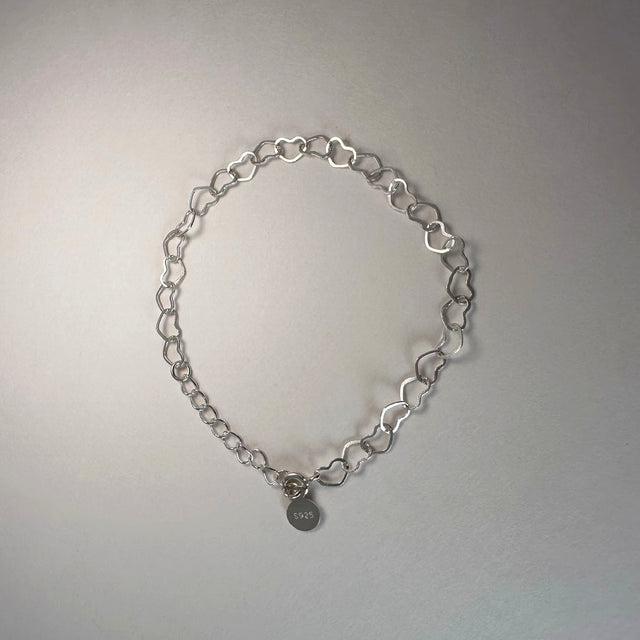 A beautifully unique sterling silver bracelet crafted with interconnected heart shapes