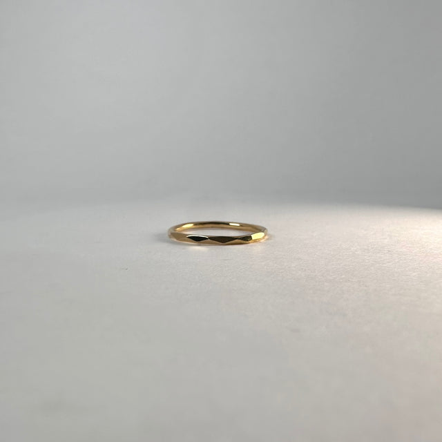 A close-up of an 18K Gold Plated Sterling Silver Amelia Ring, showcasing its unique cut facets that reflect light beautifully. Simple yet sophisticated, perfect for stacking