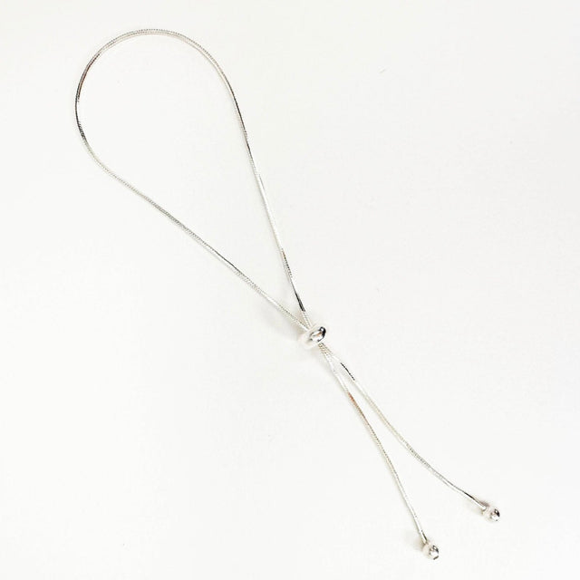 A dainty, sophisticated, and modern sterling silver adjustable bracelet, exuding simplicity and luxury. This elegant accessory effortlessly adorns your wrist with a touch of refined charm, making it a versatile and timeless addition to your jewelry collection.