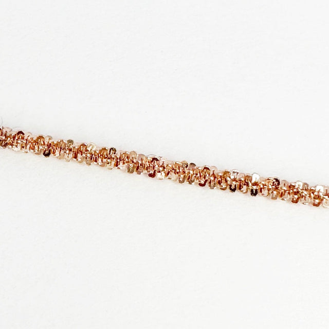 A dainty and sophisticated 14 rose gold-plated flower chain bracelet, showcasing a unique and captivating design. Its delicate floral motifs delicately intertwine, creating an enchanting and elegant accessory that effortlessly elevates your style.