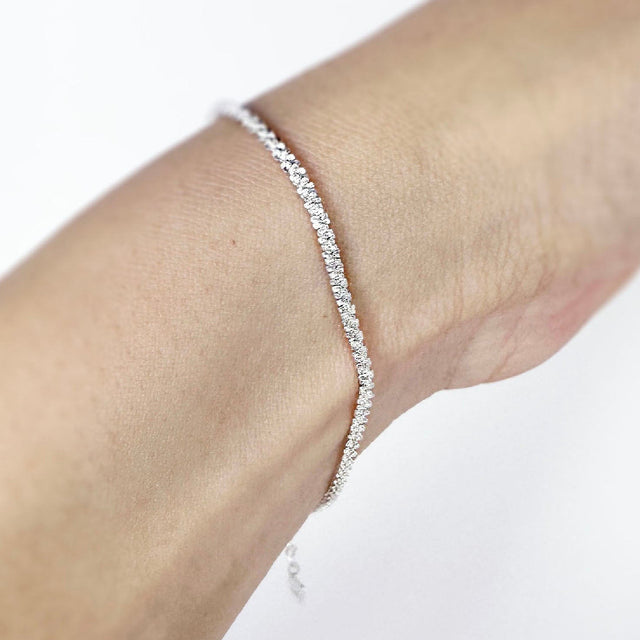 A dainty and sophisticated sterling silver flower chain bracelet, showcasing a unique and captivating design. Its delicate floral motifs delicately intertwine, creating an enchanting and elegant accessory that effortlessly elevates your style.